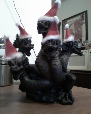 Christmas Dragon by EvilMariobot
The most amusing part is, minus the Santa hats, I have that same statue in my collection.
